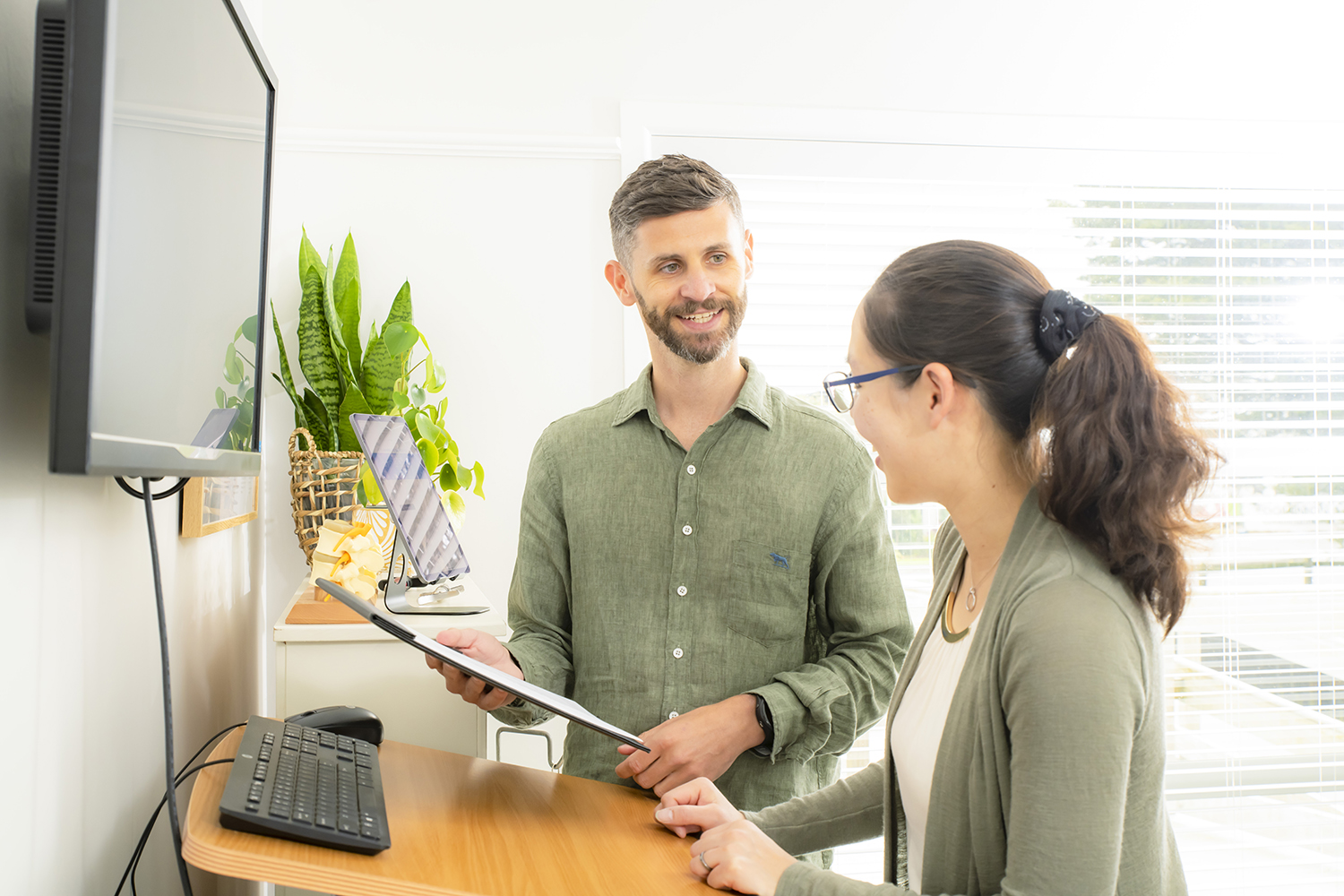 Chiropractor discussing treatment plan with smiling patient